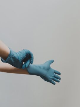 person in blue gloves and blue denim jeans