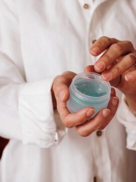 Photo by Nataliya Melnychuk person holding blue plastic container, nutmeg oil benefits for skin