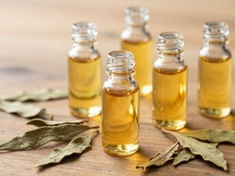 Bottles of patchouli oil with dried leaves.